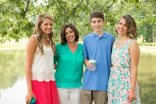 smiling family wearing colorful clothes