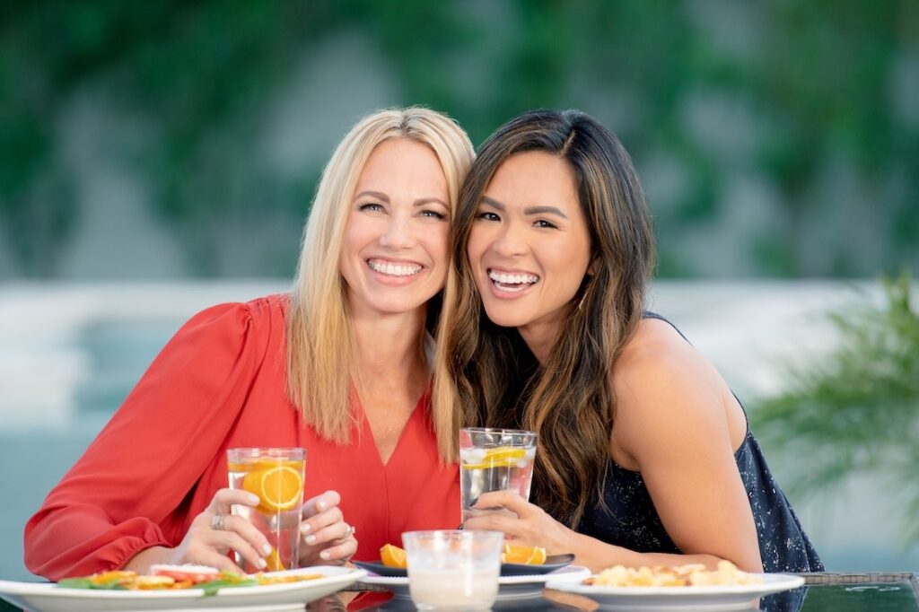 2 adult women smiling after finishing Damon Clear braces treatment.