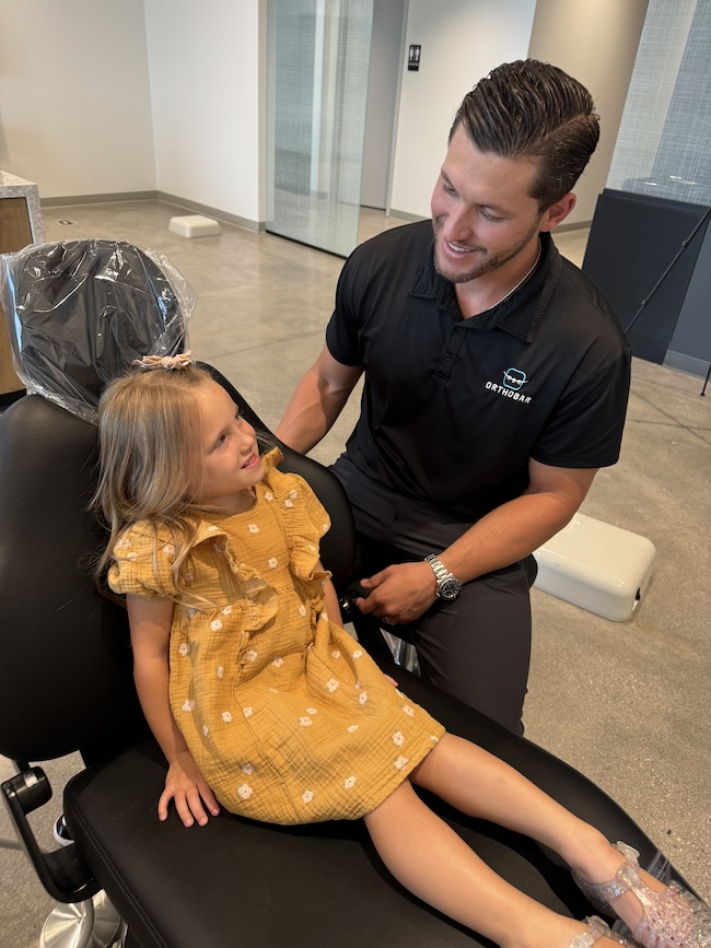 Dr. Grahl of Orthobar in Las Vegas with smiling girl preparing for orthodontic treatment.