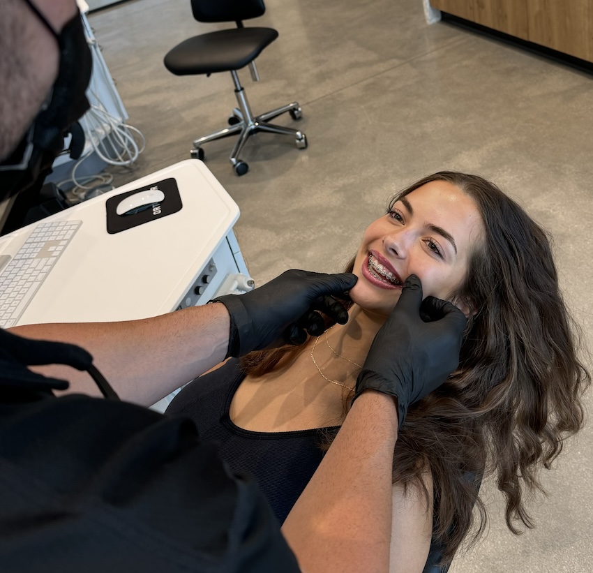 A young teenage girl who is receiving Damon Ultima braces treatment.