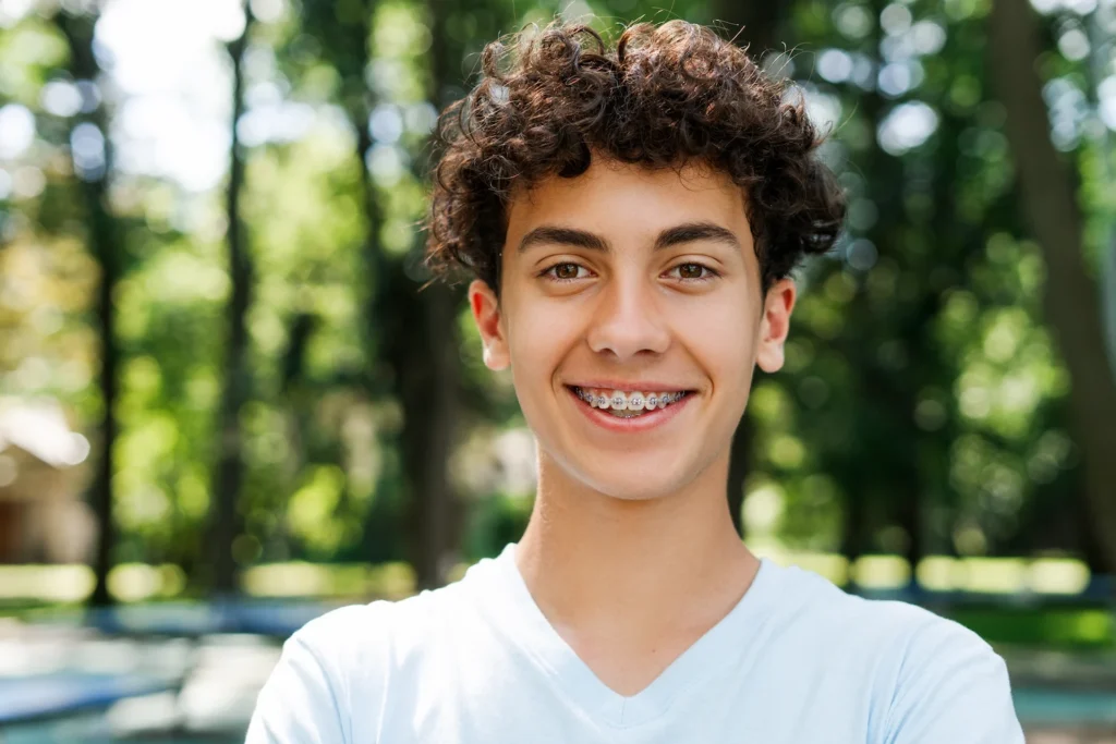 Smiling teenage boy wearing braces.