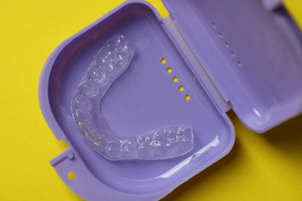 Clear retainer in purple carrying case.