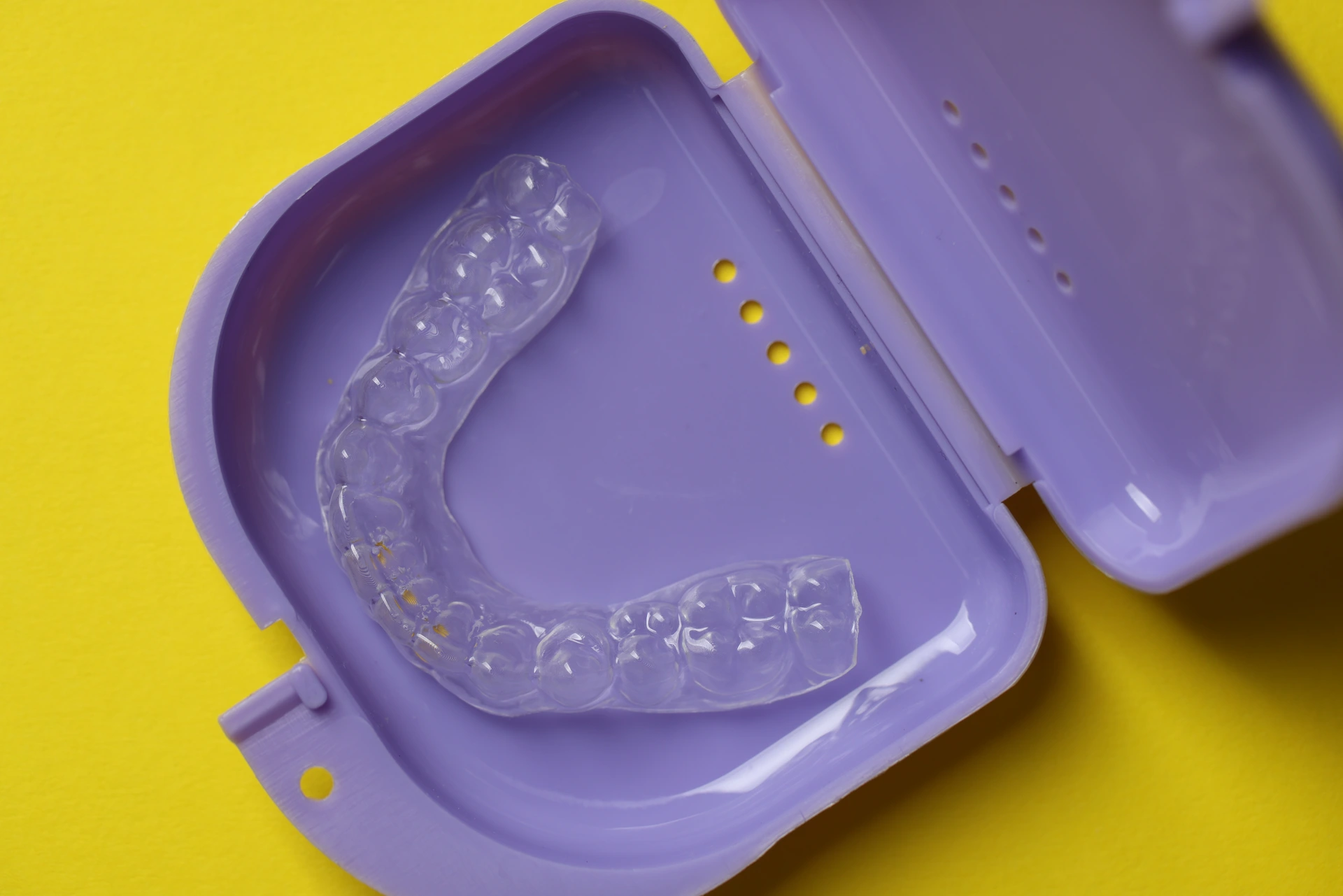 Clear retainer in purple carrying case.